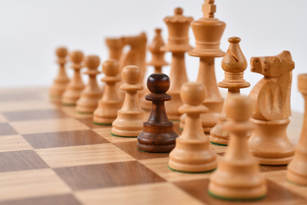 Black chess pawn on the white rank
